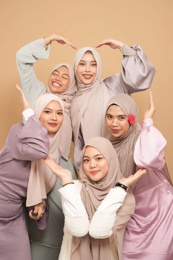 A group of women making a heart shape with their hands